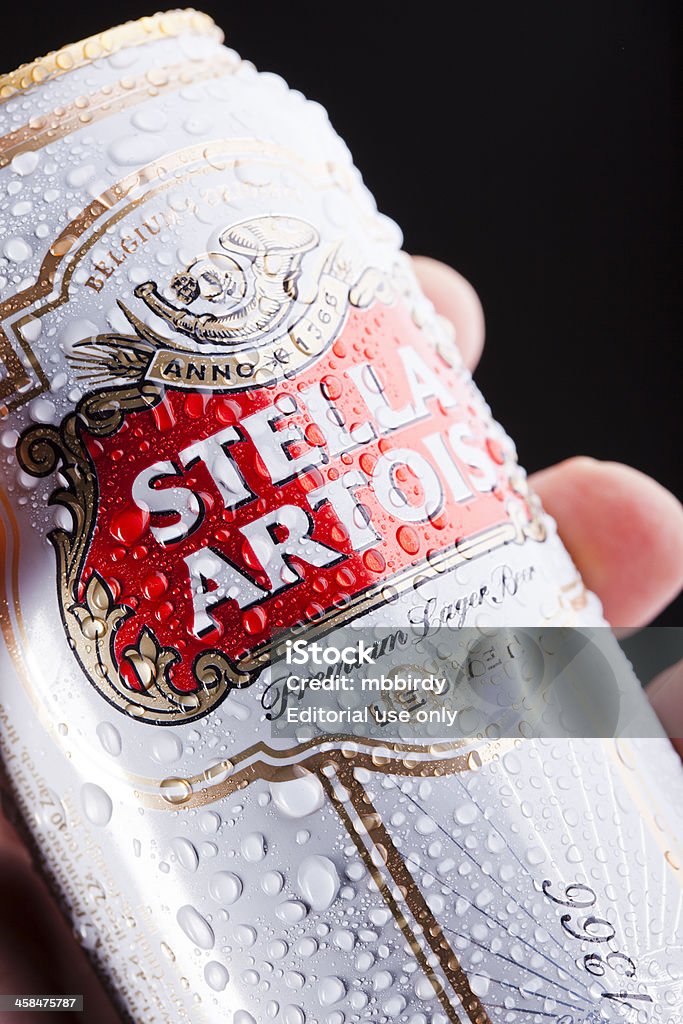 Human hand holding Stella Artois beer can Ljubljana, Slovenia, March 3, 2011: A human hand holding Stella Artois premuim lager beer 0,5 l can. Text Anno 1366 in Stella Artois logo tells the origin of brewing - city Leuven. Addiction Stock Photo