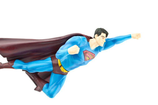 Suffolk, Virginia, USA - April 13, 2011: A horizontal studio shot of the cartoon Superhero character Superman in flight. Superman is owned by DC comics and Warner Bros.