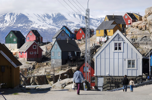 Uummannaq, Greenland - June 11th, 2006: Traditional wooden house and local people on the Inuit island of Uummannaq on the west coast of Greenland