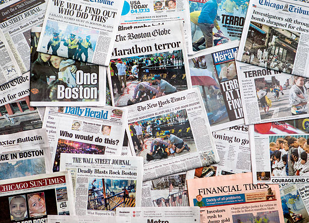 Boston Marathon Bombing headline collage featuring globe Carol Stream, IL, USA, April 20, 2013: A pile of local and national newspapers, including the Boston Globe, with headlines on the front pages reporting stories in the days immediately following the Boston Marathon Bombing terrorism stock pictures, royalty-free photos & images
