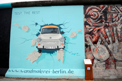 Berlin, Germany - October 21, 2009: Trabant painting on Berlin wall at East Side Gallery in Berlin Friedrichshain (former East Berlin).