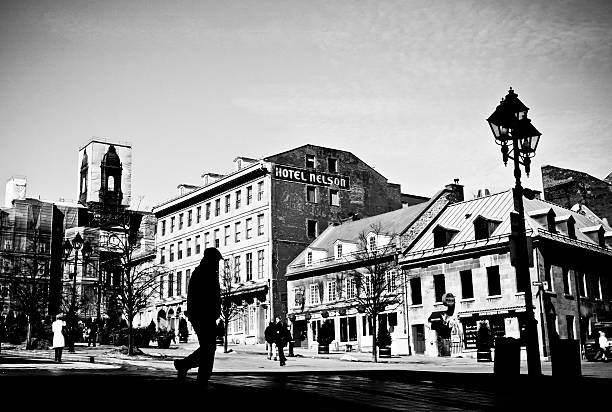 Montreal's Place Jacques-Cartier Montreal, Quebec, Canada - March 4, 2010: The silhouette of a man is walking on the Place Jacques-Cartier in the Old Montreal on a sunny March day. place jacques cartier stock pictures, royalty-free photos & images