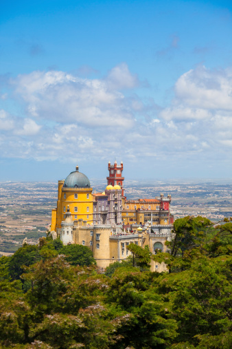 Sintra, Portugal - July 5, 2012: Panorama of Pena National Palace above Sintra town at a summer day. Visible some unrecognizable people in the rooftops