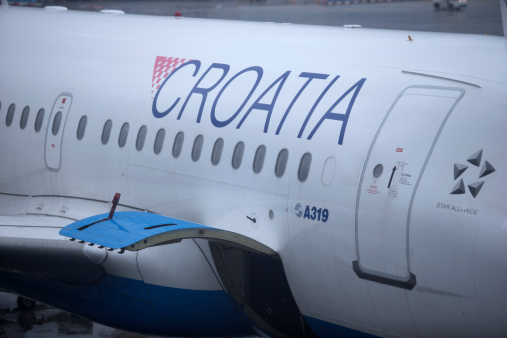 Frankfurt, Germany - July 3, 2013: View through window looking at part of Croatian airlines on an overcast rainy day