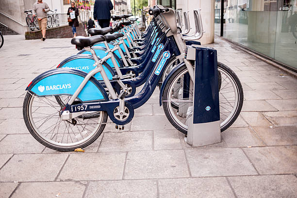 Public Bikes in London London, England - September 26, 2013: City-owned bicycles racked up and ready for commuters to rent near Charing Cross Station boris bus stock pictures, royalty-free photos & images