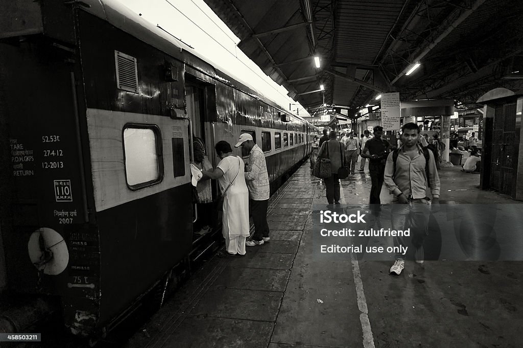 Embarking the Train in India New Delhi, India - September 21, 2013: An elderly lady embarks on a train at New Delhi train station in India. New Delhi Stock Photo