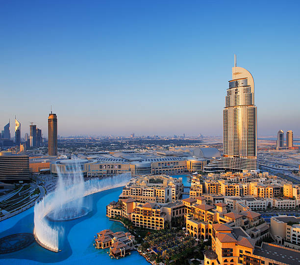 Dubai, UAE - May 7, 2010: The Dubai Fountain is set on the 30-acre manmade Burj Khalifa Lake. 63-storey, 302.2 m Address Hotel is visible on the right