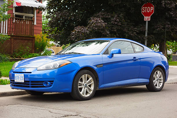 Hyundai Tiburon Hamilton, Canada - September 15, 2013: Blue colored Hyundai Tiburon GK F/L2 sports car parked on the street. 21st century style stock pictures, royalty-free photos & images