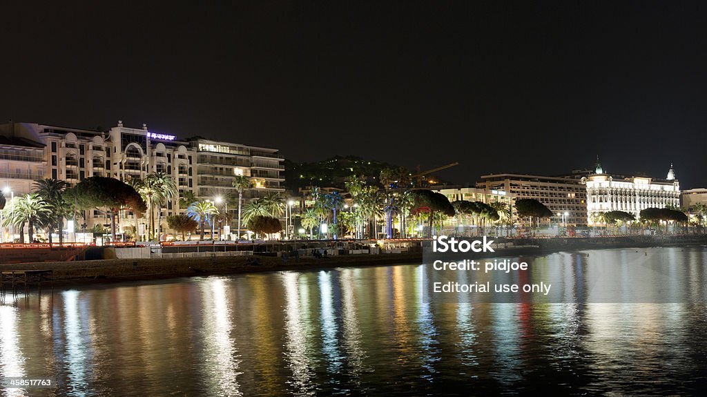 Promenade La Croisette in Cannes France at night Cannes, France - April 25, 2010: View from pier on Boulevard de la Croisette, also known as Promenade de la Croisette, at night. The boulevard goes along the coastline in Cannes for 2 km and is well known for expensive fashion and jewelry shops, luxerious restaurants and hotels. Boulevard Stock Photo