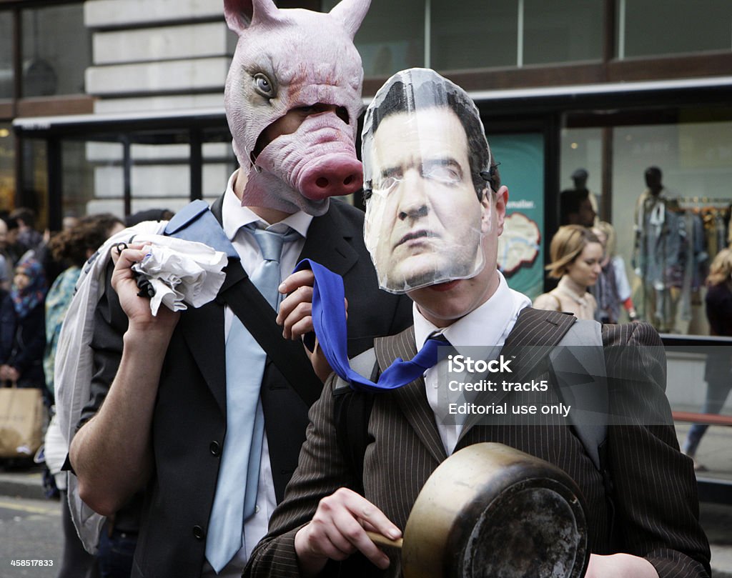 George and the Banker London, UK - March 26, 2011: A pair of UK Uncut campaigners on London\'s Oxford Street.  Wearing masks to imitate George Osbourne, the Conservative Chancellor of the Exchequer, and a pig head mask to symbolise the greed of the banking system the pair get into the spirit of the UK Uncut movement which encourages \'civil disobedience\' in its efforts to draw attention to UK corporate tax avoidance. George Osborne Stock Photo