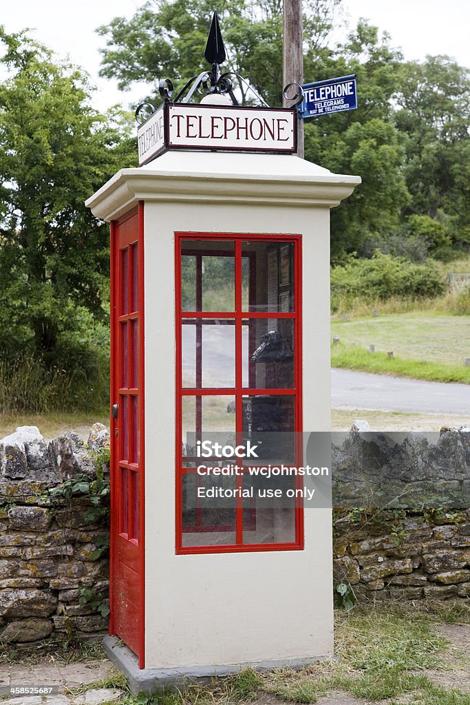 Telephone and Telegraph Box Tyneham, England - July 27, 2013: Public Mark One Telephone and Telegraph Box, red and cream with a blue sign on the telegraph pole Antique Stock Photo