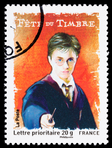 Sacramento, California, USA - March 19, 2011: A 2000 France postage stamp with an illustration of Daniel Radcliffe in the role of Harry Potter, holding a wand. The Harry Potter series of seven books was written by J.K. Rowling and is the best-selling book series in history. The series was made into eight movies (the last book was split into two parts), and the movie series is the highest grossing series in history.