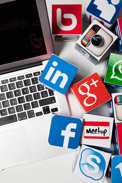Apple laptop with social media icons stock photo