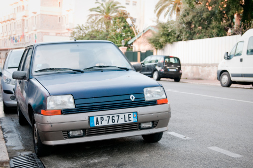 Juan-les-Pins, France - March 26, 2011: Blue Renault R5 parked on the street in Juan-les-Pins, a tourist town near Antibes and Nice at the CA'te d'Azur in Southern France. The car has scratches and dents, as can be expected due to its age. The Reanult R5 is a famous small-sized car in France. This version was built from 1984 to 1996, and is still built under license in Iran.