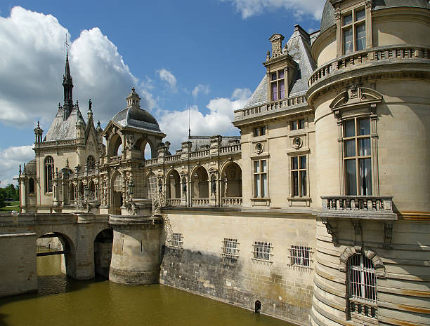Chantilly, France- May 12, 2012: Chateau de Chantilly ( Chantilly Castle ), located in the town of Chantilly, France. The Chateau consists of two buildings: Petit Chateau (built in 1560) and Grand Chateau (was destroyed during the French Revolution and rebuilt in 1870). The Chateau is Musee Conde - one of the best art galleries in France