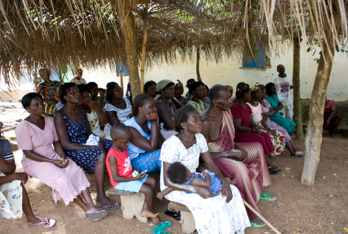 Ho, Ghana - April 24, 2008: Micro-finance, giving small loans to impoverished borrowers to create income-generating activities, has exploded in popularity in recent years.  Here, a group of prospective borrowers listen to a proposal outside of Ho Municipality, in Eastern Ghana.