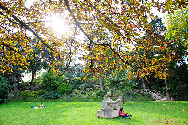 Paris, France - September 26th, 2013 : People enjoying a warm September on the lown of Montsouris garden in Paris 
