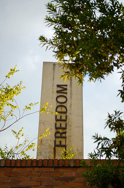 Freedom pillar outside entrance to the Apartheid Museum in Johannesburg Johannesburg, South Africa - April 5, 2012: Freedom pillar outside entrance to the Apartheid Museum in Johannesburg apartheid sign stock pictures, royalty-free photos & images