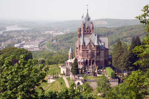 Bonn, Germany - April 23, 2011 : Drachenburg Palace located on Dragon`s Rock was constructed in the late 19th century, recently restored (2003) and down the Rhine River near the city of Bonn in the background. Today the Palace is in possessionof the State Foundation of North Rhine-Westphalia.