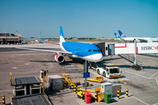 London, United Kingdom - April 25, 2011: BMI (British Midland International) Airbus A320 aircraft at Heathrow Airport. Gangway attached, ready for departure. The Airbus A320 is Airbus's successful short distance aircraft. Heathrow Airport is England's biggest airport. BMI is a British airline.