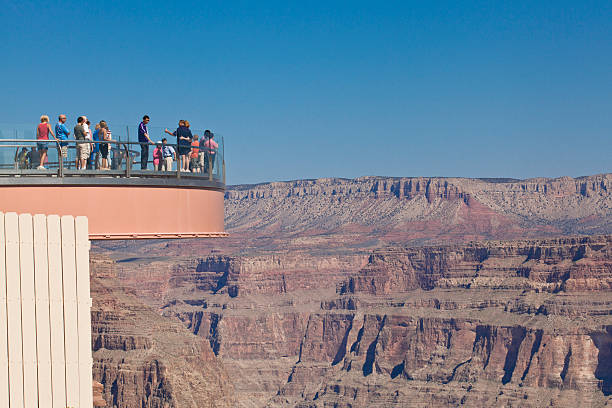 The Grand Canyon Skywalk Grand Canyon, Arizona, USA - September 30, 2012: The Grand Canyon Skywalk is a transparent horseshoe-shaped cantilever bridge and tourist attraction in Arizona near the Colorado River on the edge of a side canyon in the Grand Canyon West area of the main canyon.  The United States Geological Survey (USGS) topographic maps show the elevation at the Skywalk's location as 4,770 ft (1,450 m) and the elevation of the Colorado River in the base of the canyon as 1,160 ft (350 m), and they show that the height of the precisely vertical drop directly under the skywalk is between 500 ft (150 m) and 800 ft (240 m). grand canyon of yellowstone river stock pictures, royalty-free photos & images