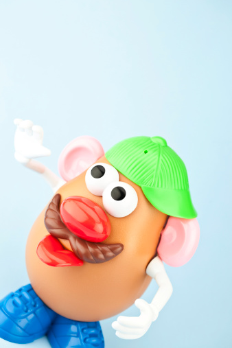 Suffolk, Virginia, USA - April 30, 2011: A vertical studio shot of the children\\'s toy, Mr Potato Head. Here Mr. Potato Head is wearing a cap and sticking out his tongue. Mr. Potato Head is made by the toy company Hasbro.