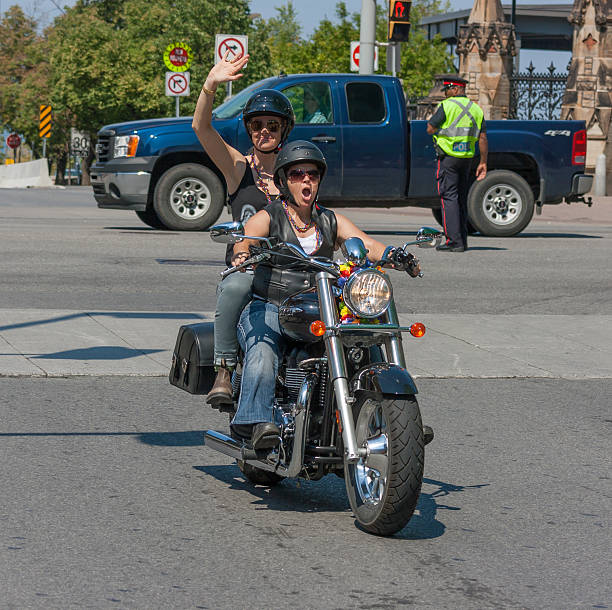 Ottawa, Canada - August 26, 2012: Two women riding a motorcycle in the Capital Pride Parade in Ottawa, Ontario.