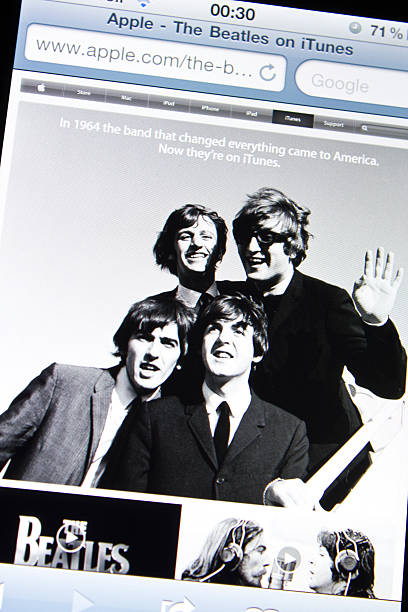 Istanbul, Turkey - May 27, 2011: Apple Iphone 4 screen showing the website of Apple Itunes homepage with the music band The Beatles. The website announces that the songs of The Beatles are now on sale on iTunes.