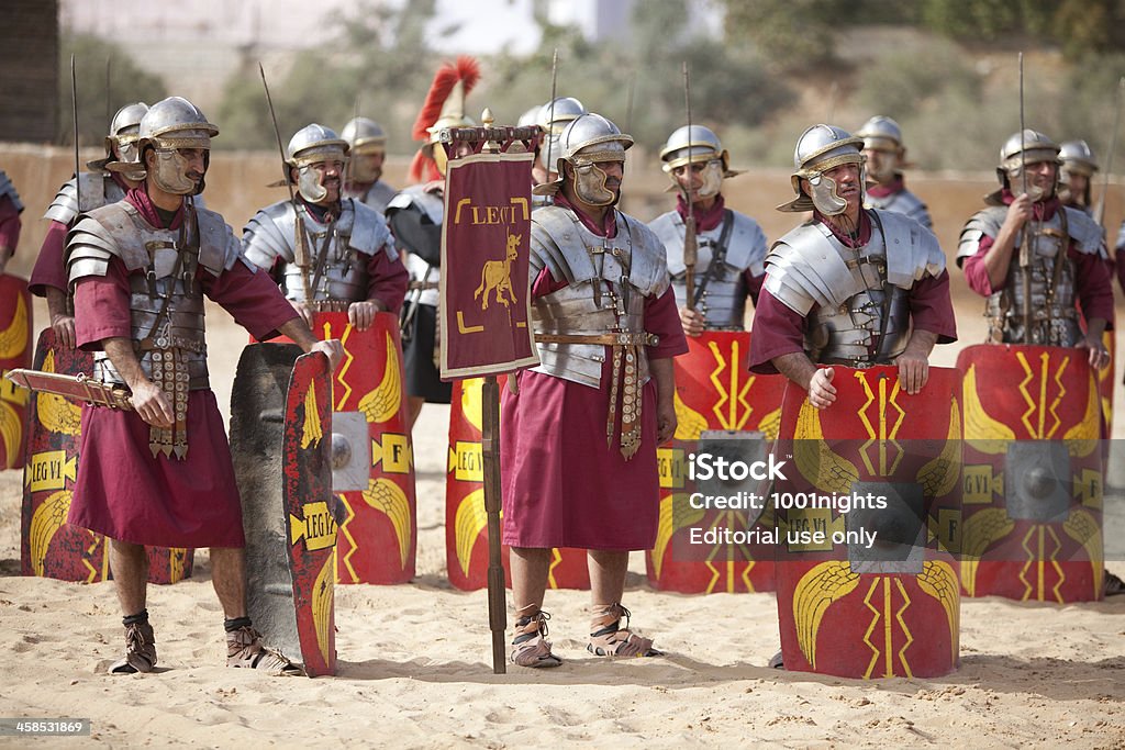 Legion in formation - Jerash, Jordan Jerash, Jordan - December 20, 2010: Legion VI Ferrata, the &quot;Ironclads&quot; stand at attention in the arena, as part of a performance at a hippodrome in Jerash, situated in the north of Jordan.Jerash is known for the ruins of the Greco-Roman city of Gerasa, also referred to as Antioch on the Golden River. The Roman Army and Chariot Experience (RACE), in co-operation with the Jordan Ministry of Tourism and the Jordan Tourism Board, have introduced a show featuring Roman Army warfare techniques, gladiators and Roman chariots races, to bring to life historical events that took place in the ancient arena. Roman Centurion Stock Photo