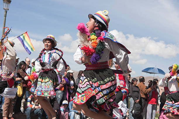 Young Women Dancing during Cusco Parade Cusco, Peru - June 19, 2010: Young women wearing elaborate Peruvian costumes perform a Peruvian dance during the day time parades which are part of the week long festivities of the Inti Raymi Festival. The parades are held in Plaza de Armas, Cuscos' main square. inti raymi stock pictures, royalty-free photos & images