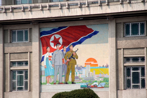 Pyongyang, North Korea. April 3rd, 2013. A colorful propaganda mural on the front of an office building in Pyongyang.