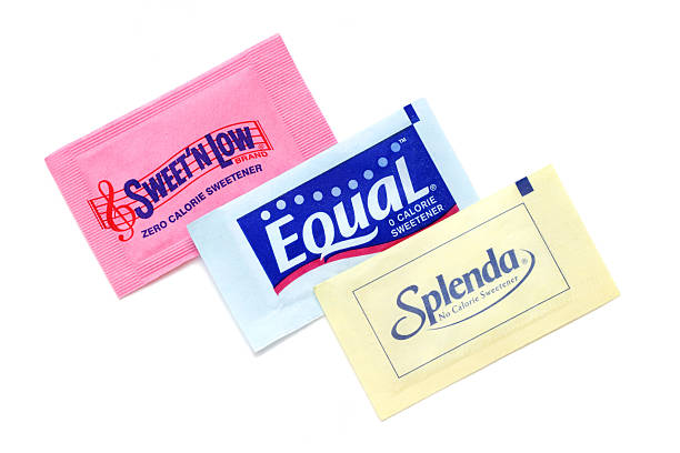 Sweet N Low, Equal, and Splenda artificial sweeteners West Palm Beach, USA - April 12, 2011: Product shot of three different brands of zero calorie sweeteners: Sweet N Low in pink, Equal in blue, and Splenda in yellow. Each brand is an artificial sweetener used as a sugar substitute. sachet stock pictures, royalty-free photos & images