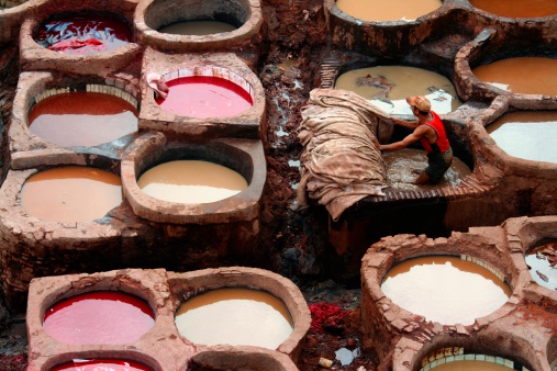Fez, Morocco - October 7, 2008: At the Fez tanneries, it seems like time has stood still for a thousand years. A worker washes some leathers, before to dye them using pretty much the same tecnique in vogue in the Middle Ages.