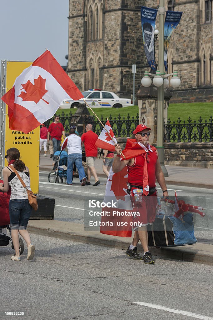 Street Vendor Walking on Canada Day Ottawa, Canada - July 1, 2013: A street vendor walking by Parliament Hill during Canada Day in downtown Ottawa, Ontario. 2013 Stock Photo