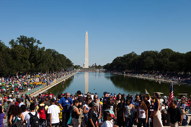 Crowd at a rally in Washington D.C. Washington DC, USA, October 2,2010. A shot of the crowd at the One Nation Rally, a march for union and civil rights. The Reflecting Pool, Washington and the Capitol building can be seen in the distance. washington monument reflecting pool stock pictures, royalty-free photos & images