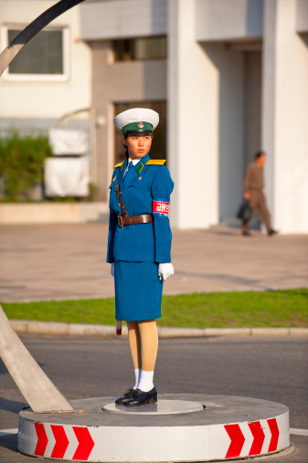 Pyongyang, North Korea - Oct 07, 2009: A charming police woman standing on the platform for in street, Pyongyang. The female polices are considered as one of the country\\'s icons in North Korea.
