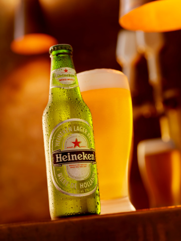 Calgary, Canada - April 5, 2011: Ice Cold Bottle and Glass of Heineken Beer shot in a Bar Setting, Heineken is a Beer made in Holland.