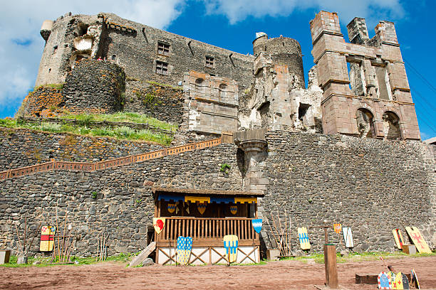 Murol, France - July 30, 2013: Inside the Castle of Murol in the Puy-de-DA'me department in Auvergne in massif central in France. It is on top of a hill in middle of an amazing volcano landscape. Threre are swords, spears and shields, ready for a knight competition.