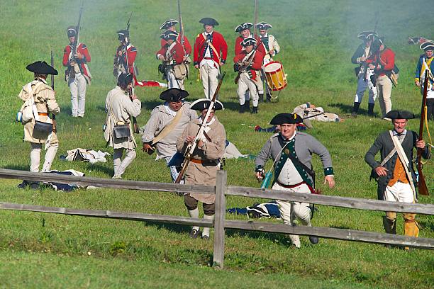 The American Rebel Soldiers Retreat Fredonia, Wisconsin, USA, August 31, 2013: At the annual Pioneer Village Revolutionary War encampment, reenactors portraying Continental line forces consisting of 3rd New York Regiment and militia, retreat from the crown forces, after taking too many casualties. battle reenactment stock pictures, royalty-free photos & images