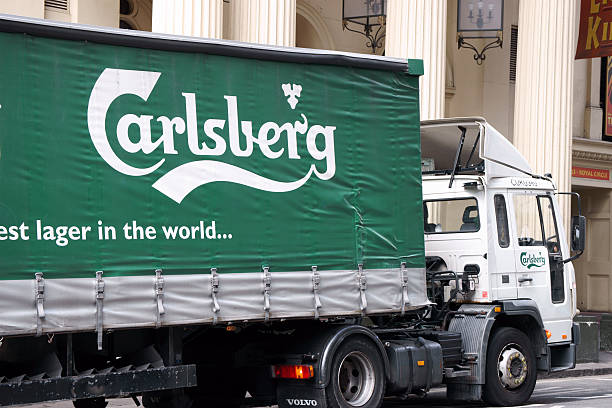 Green Carlsberg truck parked in London street London, United Kingdom - May 3, 2011: Green Carlsberg truck parked in London street. Carlsberg was founded in 1847 in Copenhagen in Danmark. guinness photos stock pictures, royalty-free photos & images