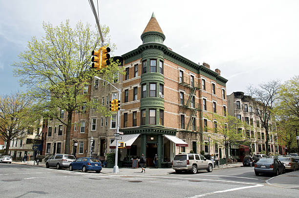Park Slope, Brooklyn, corner cafe in 19th century building, NYC New York City, USA - May 1, 2011: A late 19th century apartment building with a corner cafe is seen at 12th. Street and 8th Avenue, Park Slope, Brooklyn. city street street corner tree stock pictures, royalty-free photos & images