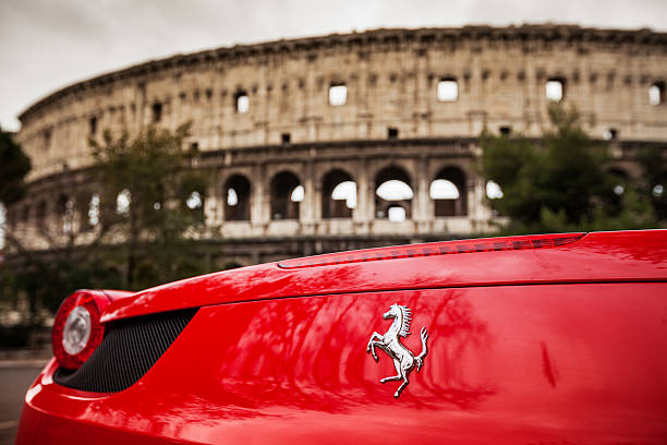 Rome, Italy - December 16, 2012: Details of a red Ferrari 458 Italia parked just in front of the Coliseum in Rome
