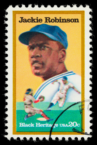 Sacramento, California, USA - March 19, 2011: A 1982 USA stamp issued to commemorate Jackie Robinson, the first African American man to play major league baseball. The stamp was designed by Jerry Pinkney and was the 5th issue in the Black Heritage series.