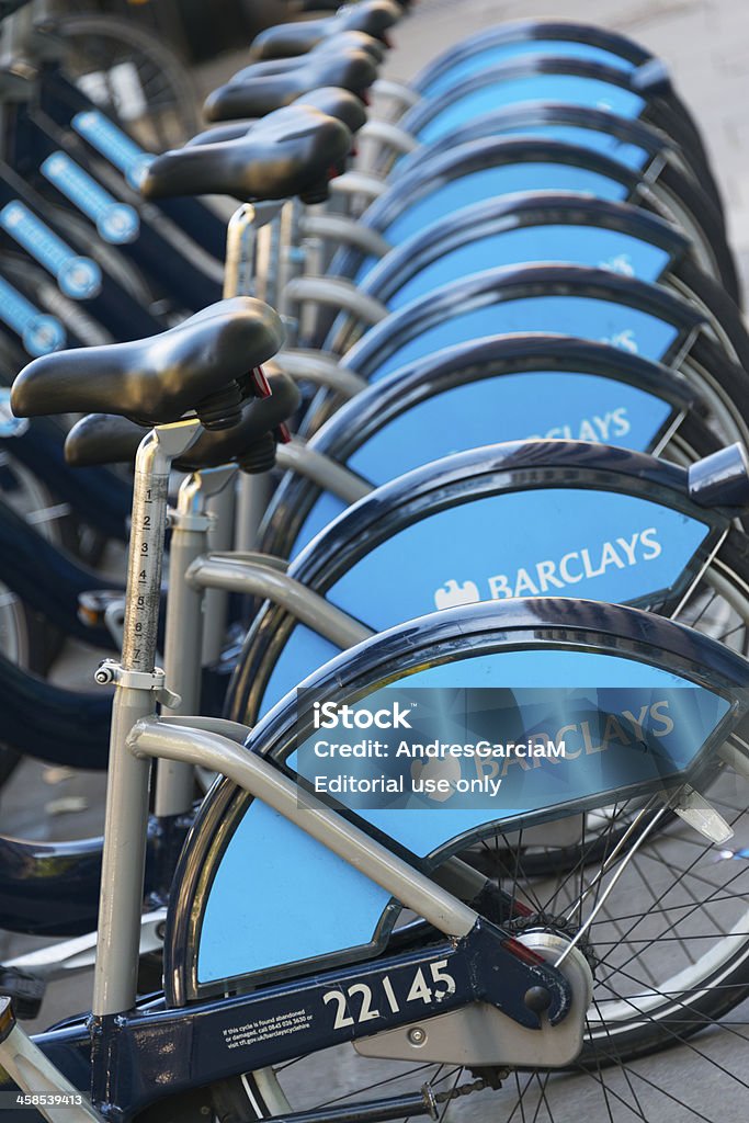 Bike station of Barclays Cycle Hire in London London, UK - September 7, 2012: Row of hire bikes lined up in a docking station in London. This bicycle sharing system was first introduced in London in July 2010, and is designed to provide a non-polluting transport alternative to more traditional services. Sponsored by Barclays Bank, the scheme is also known as Barclays Cycle Hire of 'Boris Bikes'. Barclays - Brand Name Stock Photo