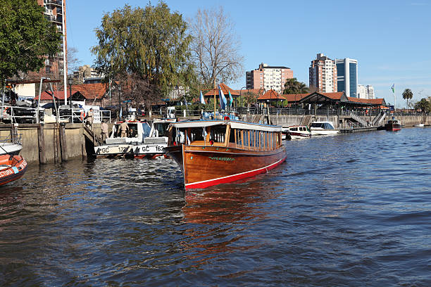 Tigre, Argentina- July 5, 2012: canal boat on Tigre, Argentina turning around, people in the background are visible