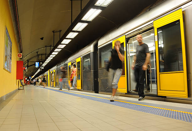 Subway Train Arrival Sydney, Australia - February 23rd, 2011: Sydney CityRail train service after arrival at Bondi Junction station in the eastern suburbs. Passengers disembarking in blurred motion. bondi junction stock pictures, royalty-free photos & images