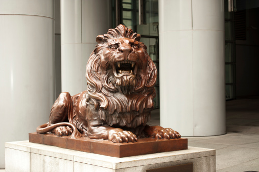 Hong Kong, China - March 31, 2010: One of the two HSBC guardian lions standing outside the bank in Hong Kong. This one is known as Stephen and the other one is called Stitt. Rubbing Stephen's teeth is supposed to bring good luck.