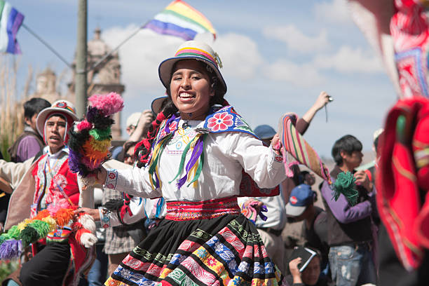 Young Woman Dancing during Cusco Parade Cusco, Peru - June 19, 2010: A young woman wearing an elaborate Peruvian costume performs a Peruvian dance during the day time parades which are part of the week long festivities of the Inti Raymi Festival. The parades are held in Plaza de Armas, Cuscos' main square. inti raymi stock pictures, royalty-free photos & images