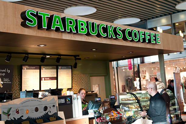 Copenhagen, Denmark - February 8th, 2011: Customers are served at Starbucks in Copenhagen Airport. Itaas one of the few Starbucks coffee shops in Scandinavia and the first one actually opened in Copenhagen Airport in 2007. Now the airport has two Starbucks.