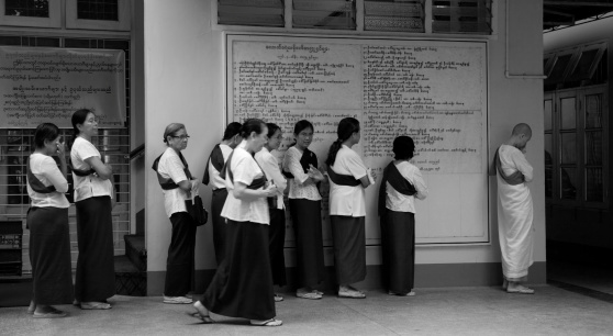 Yangon, Myanmar - January 29, 2011 Meditators waiting in line to receive their meal at Dama Yendi Meditation Center in Yangon.